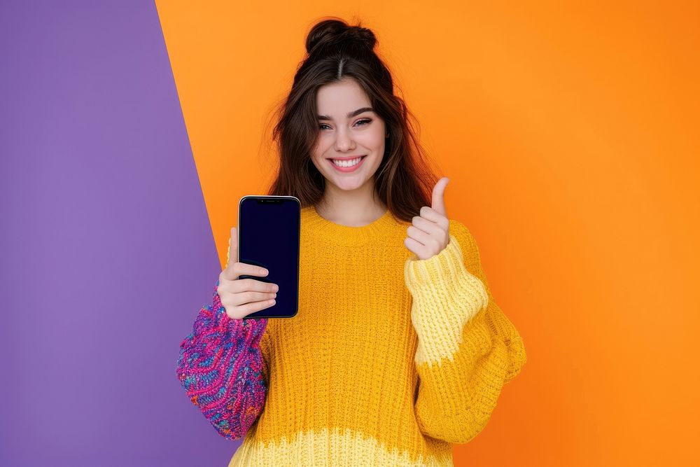 Girl showing phone screen sweater smile photographing.