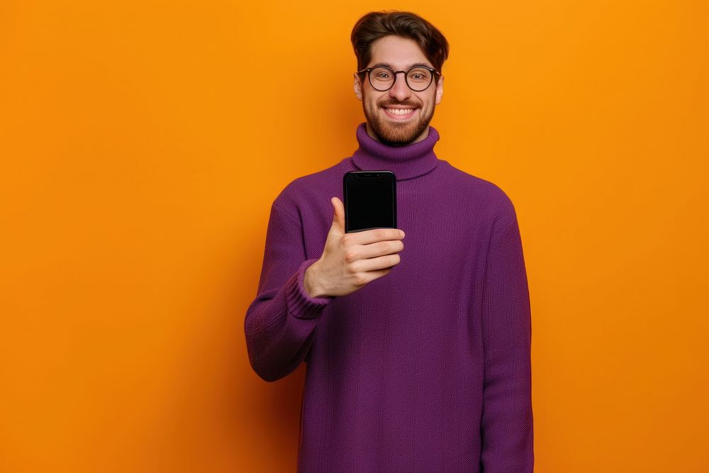 Man showing phone screen sweater selfie photo.