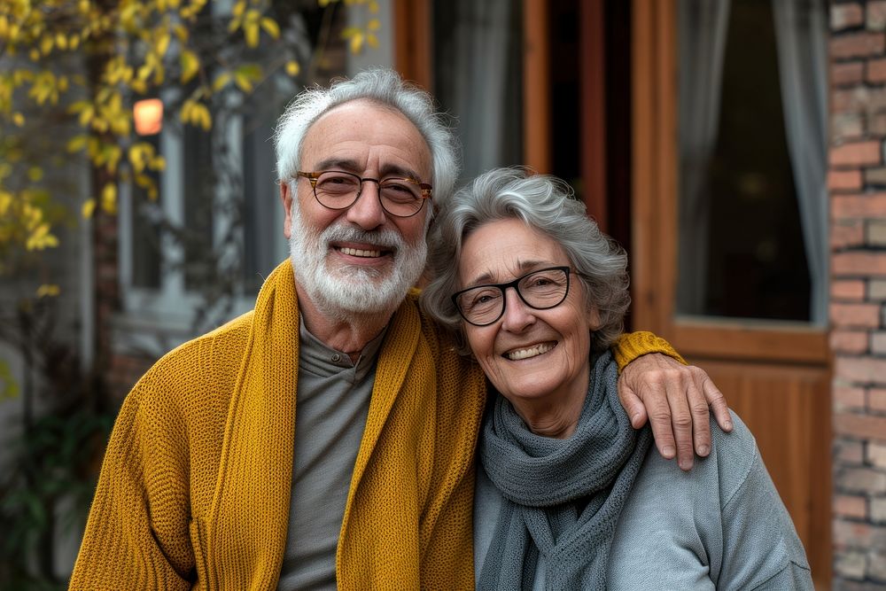 Portrait of senior couple in front of home portrait glasses adult.