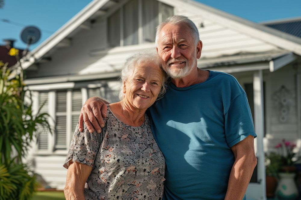 Portrait of senior couple in front of home portrait adult photo.