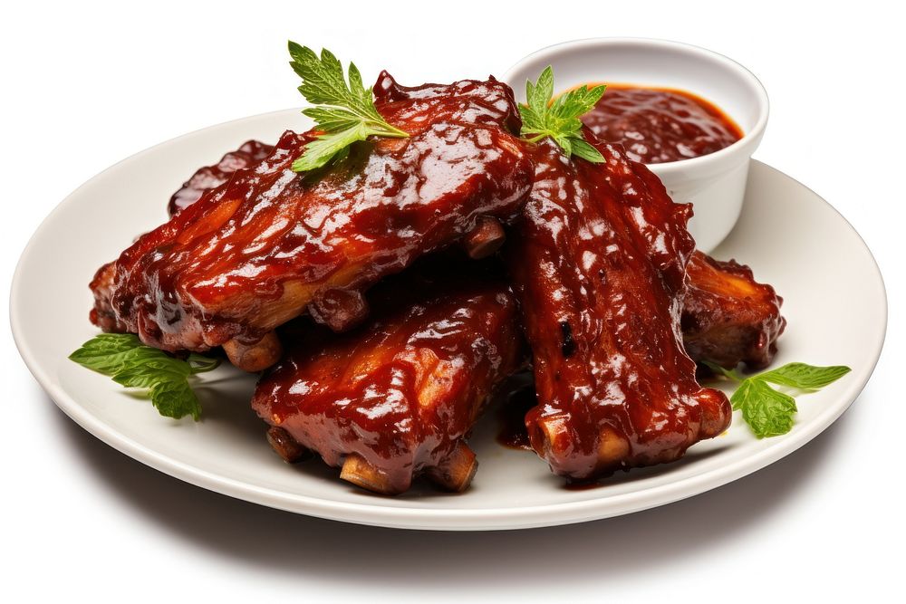 Plate of cut baby back ribs with barbecue sauce plate meat food.