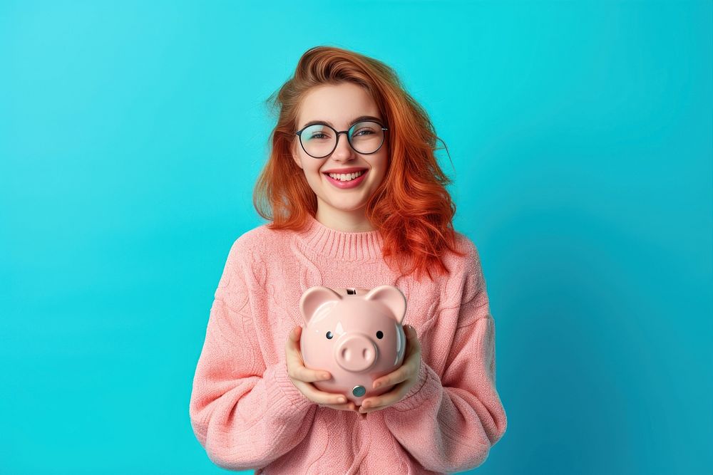 Woman who puts coin in piggy bank portrait savings glasses.