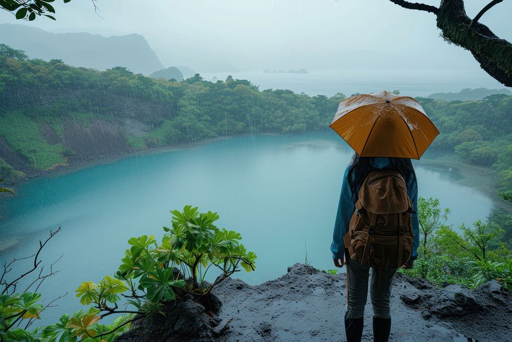 Woman in hiking clothes in the rain backpack outdoors nature.