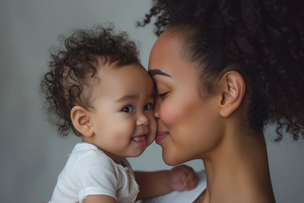 Mother and child portrait kissing adult.