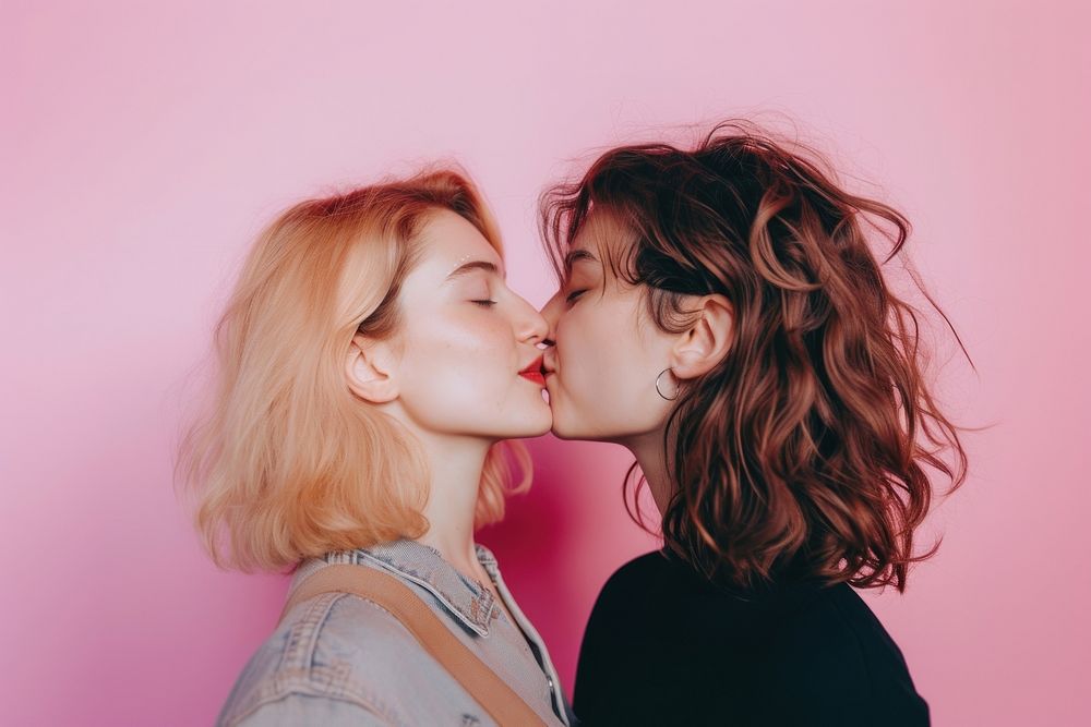 Women couple kissing adult affectionate togetherness.