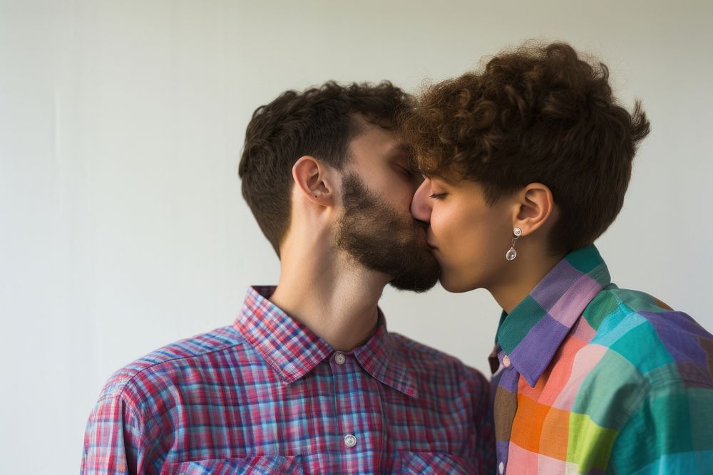 1 gays and 1 lesbian wearing colorful shirts kissing portrait adult.