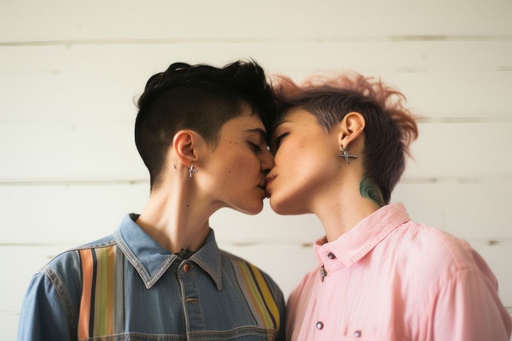 1 gays and 1 lesbian wearing colorful shirts kissing portrait photo.