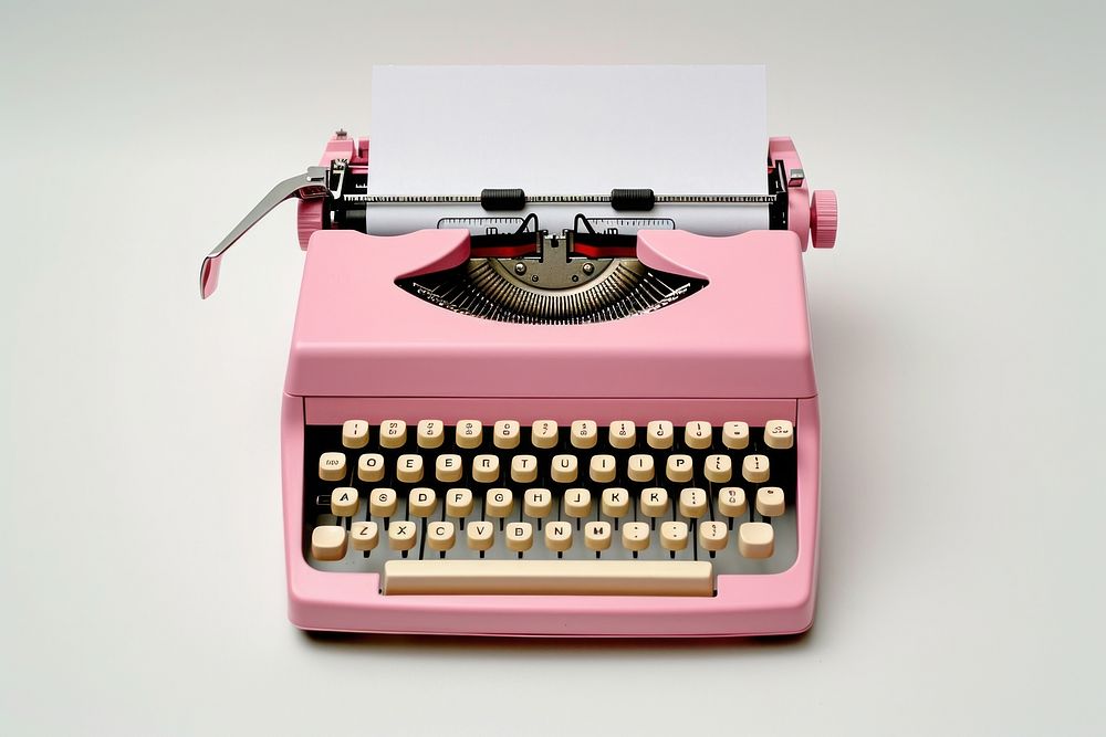 A retro pink typewriter with an empty page text correspondence electronics.