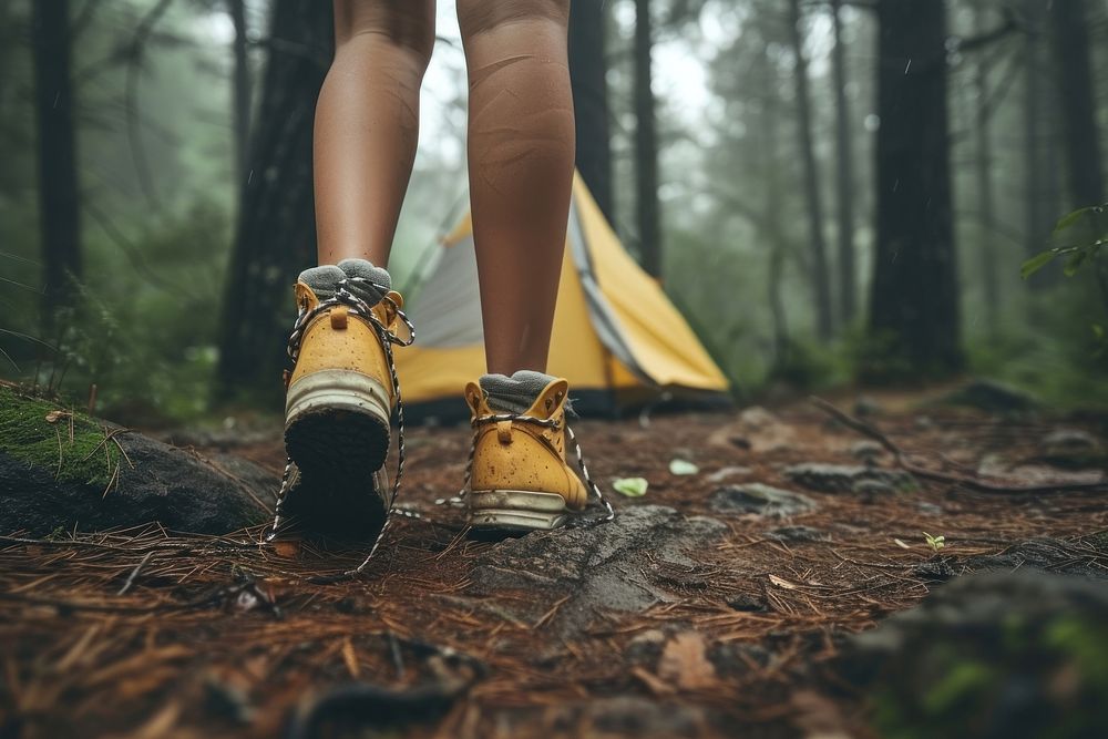 Close up leg woman standing against coming out of tent camping in the woods footwear outdoors walking.