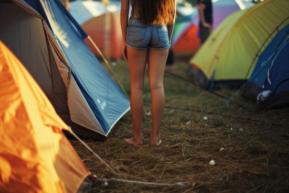 Close up leg woman standing against tent outdoors camping architecture.