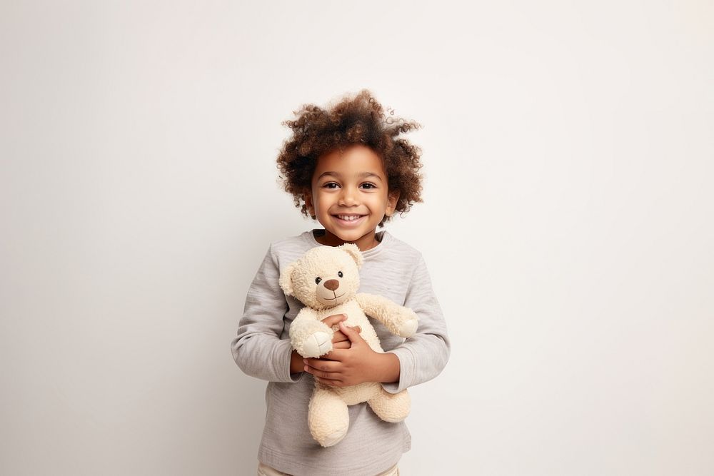 Little black boy with teddy bear portrait child smile.
