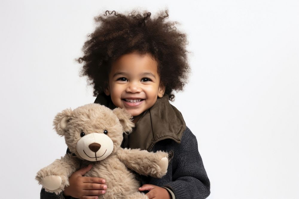 Little black boy with teddy bear portrait child smile.