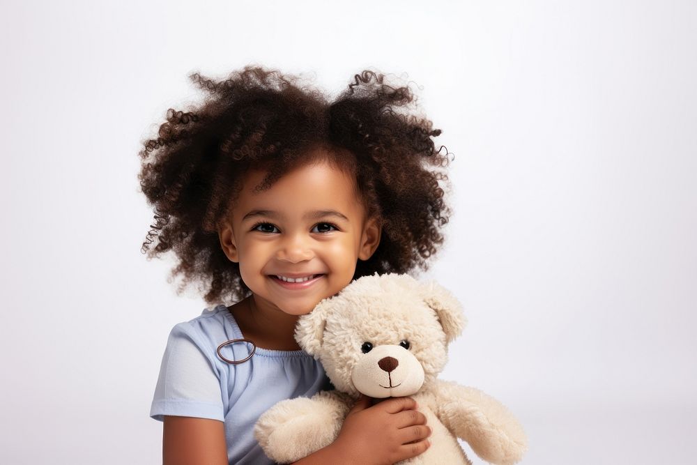 Little black girl with teddy bear child portrait smile.