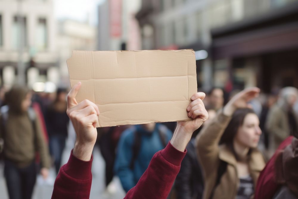 Hand holding flash mob paper sign cardboard adult box.