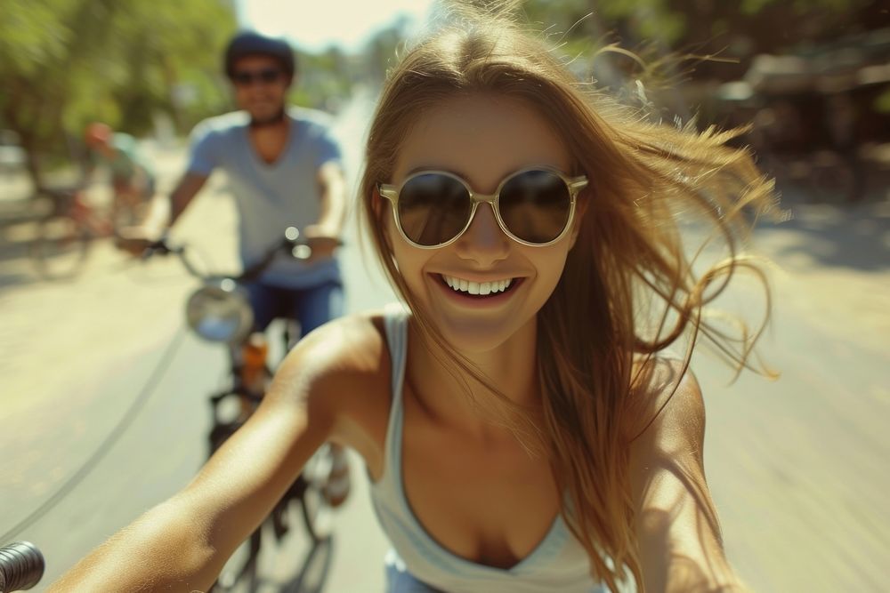 Bicycle rides sunglasses laughing portrait.
