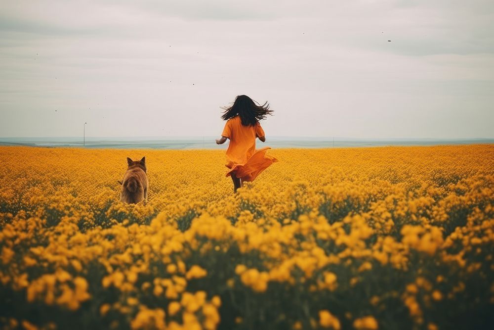 A happy girl run floating with a dog landscape flower field.
