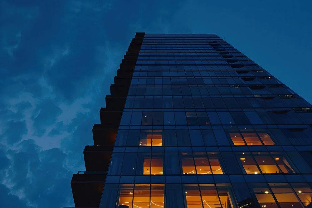Exterior of highrise building at dusk architecture outdoors tower.