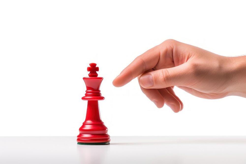 Hand pick up king chess game red white background.