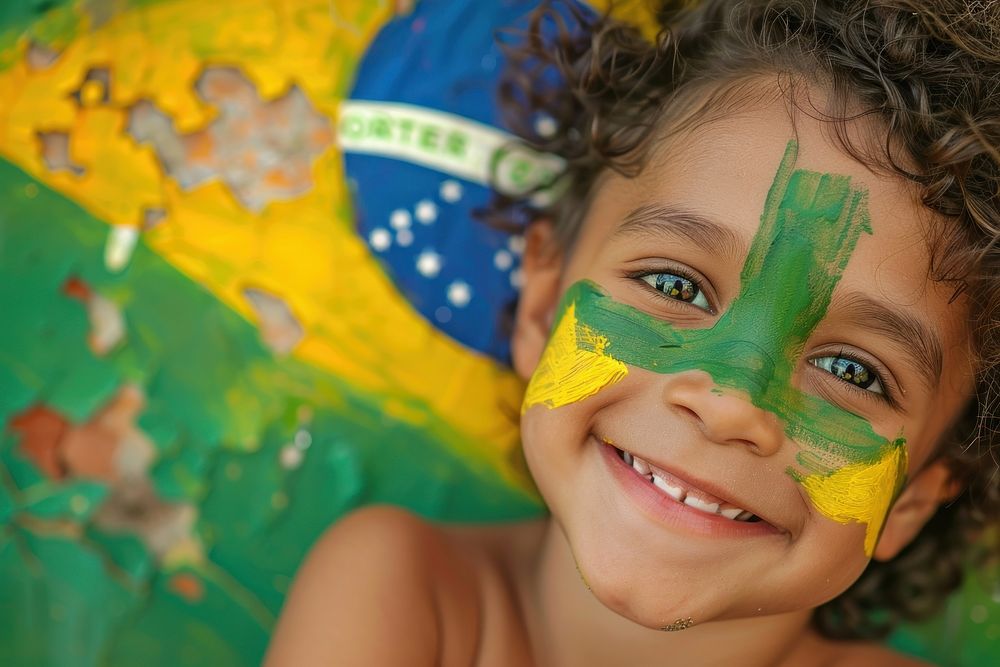 A child with a painted flag Brazilian portrait smile clapperboard.
