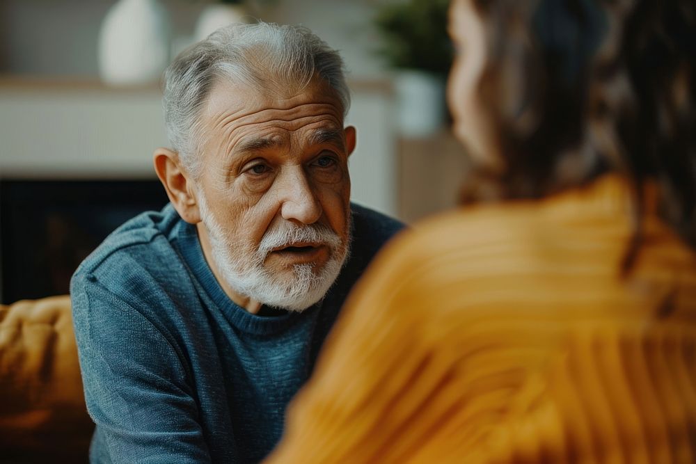 Caregiver talking with elderly conversation adult man.