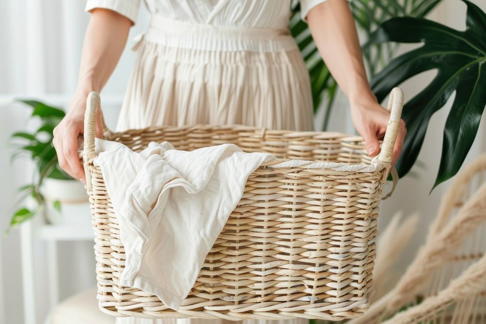 Person holding laundry basket midsection recreation container.