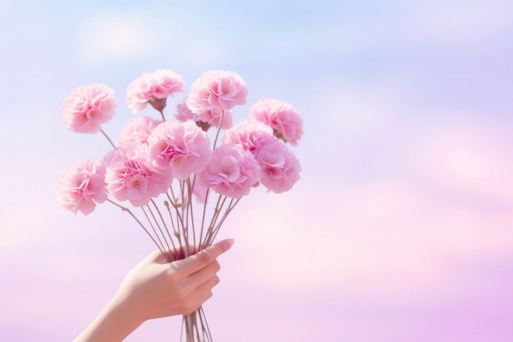Person holding flowers gradient background outdoors blossom nature.