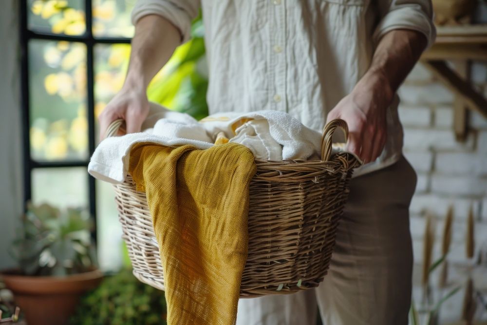 Man holding basket of laundry plant midsection recreation.