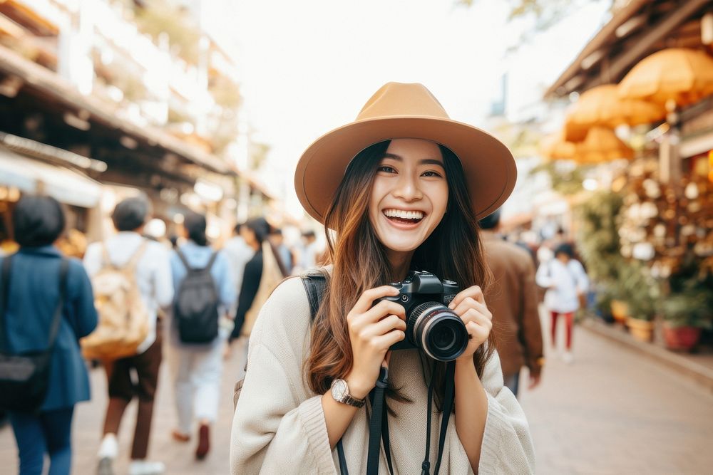 A Young tourist happily holding a camera travel smile adult.