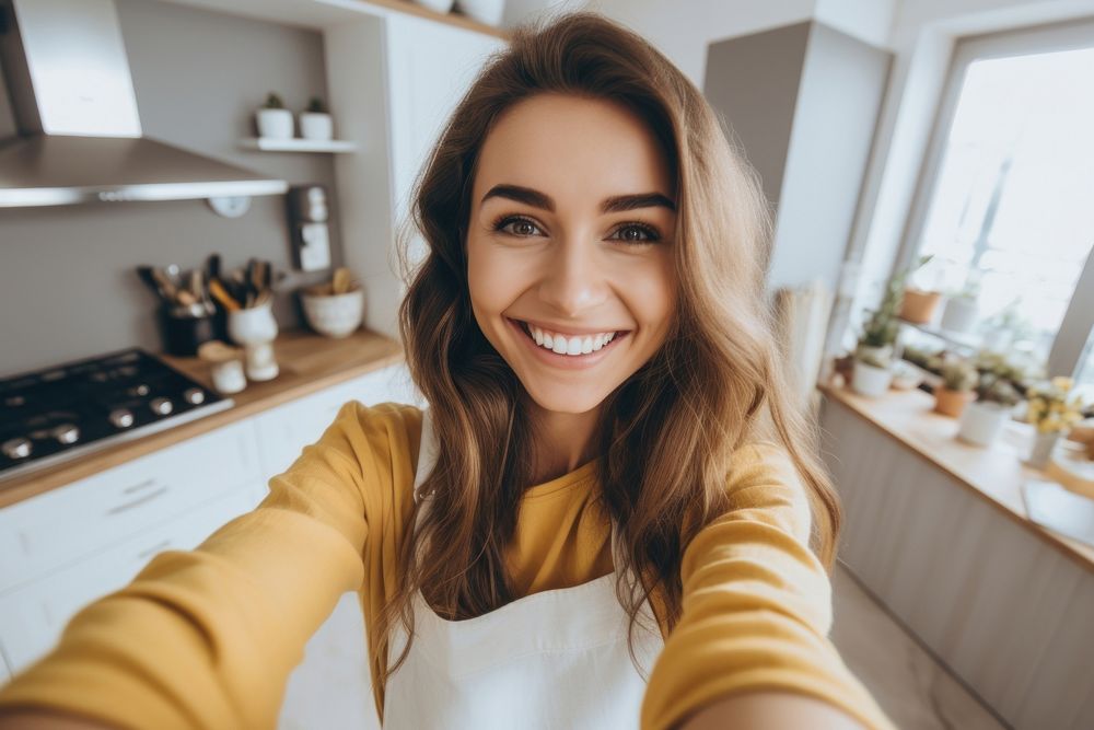 Young woman selfie gesture kitchen smile technology.