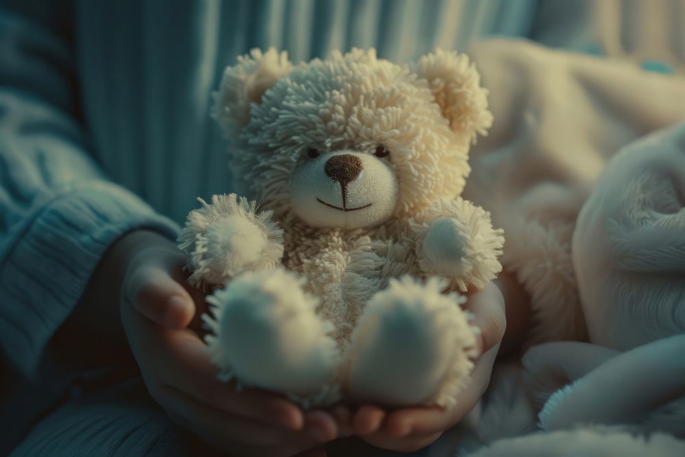 Person holding teddy bear toy representation relaxation.