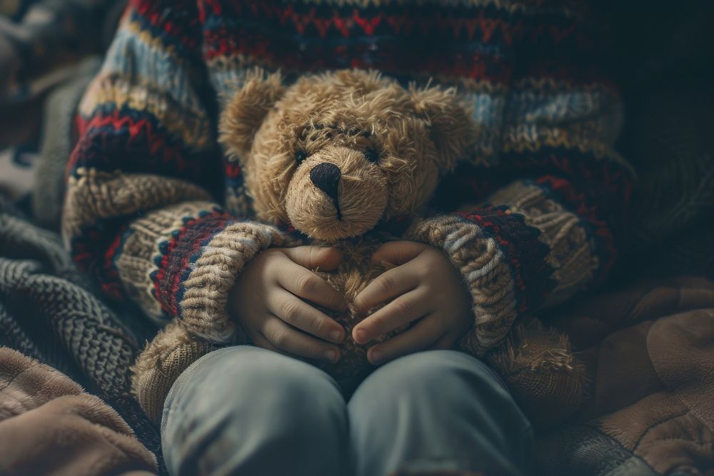 Person holding teddy bear toy representation relaxation.