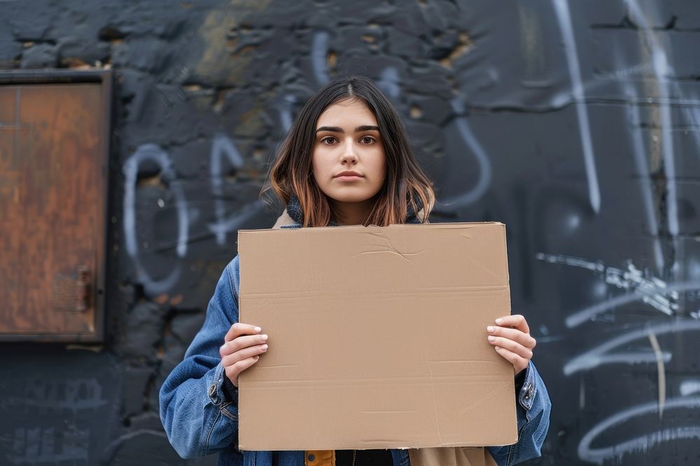 Woman holding placard homelessness architecture displeased.