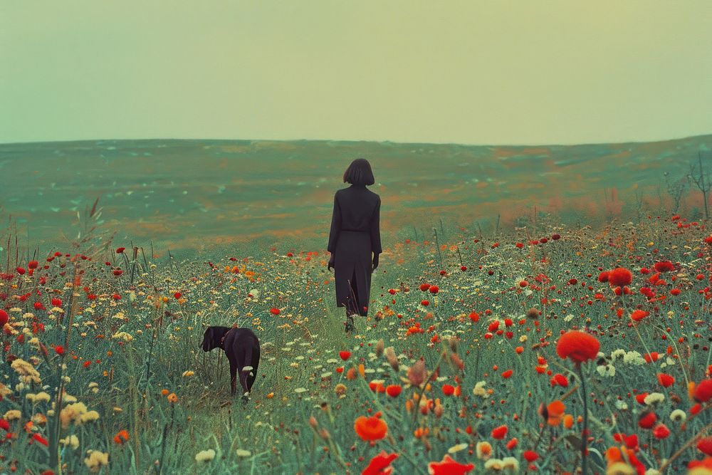 Woman walking with a dog landscape flower field.