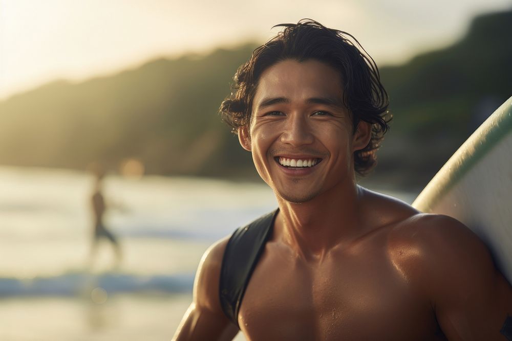 Asian surfer surfing outdoors smiling smile.