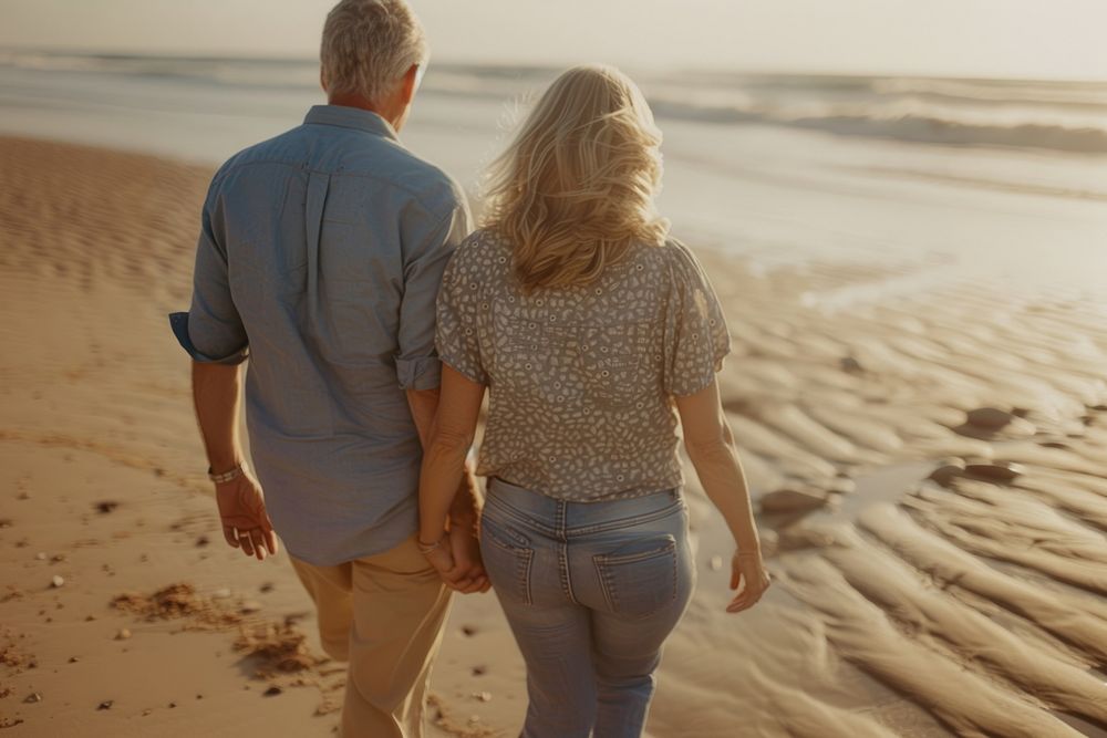 Middle-aged couple walking together summer beach adult.