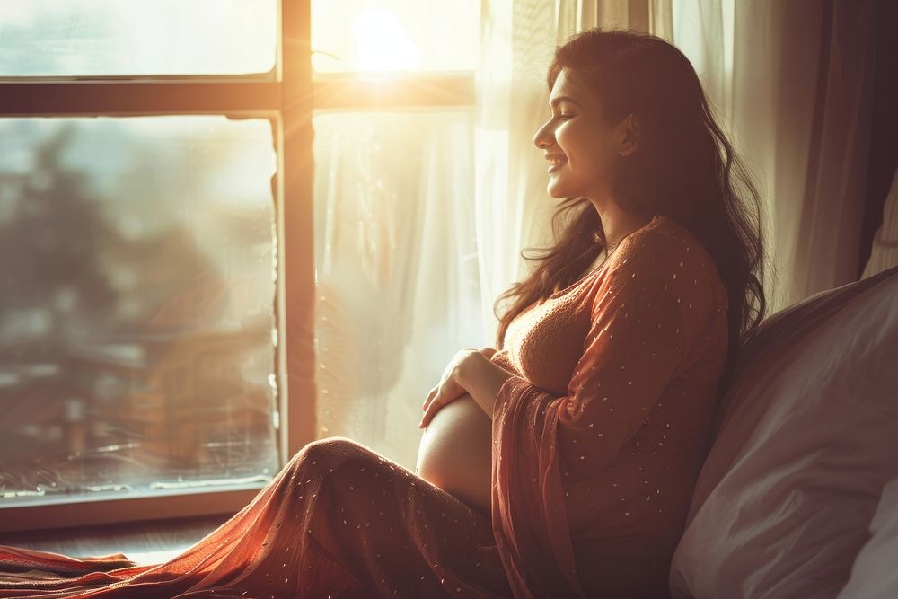Pregnancy pregnant sitting window.