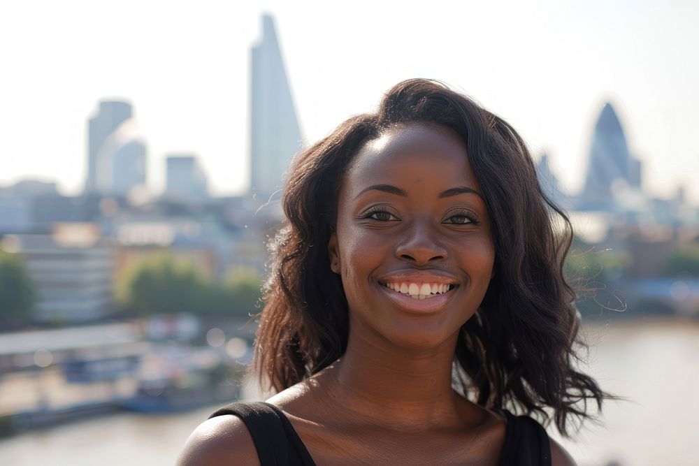Black woman smiling city cityscape portrait.