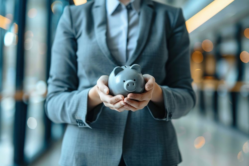 Business person holding piggy bank investment technology ammunition.