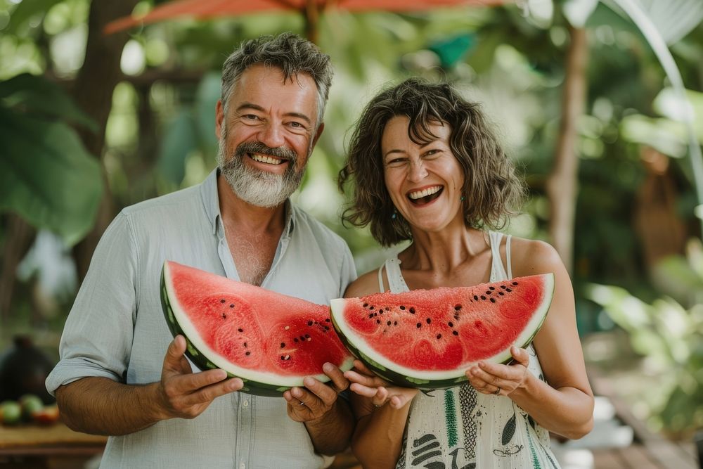 Happy middle-aged couple watermelon laughing holding.