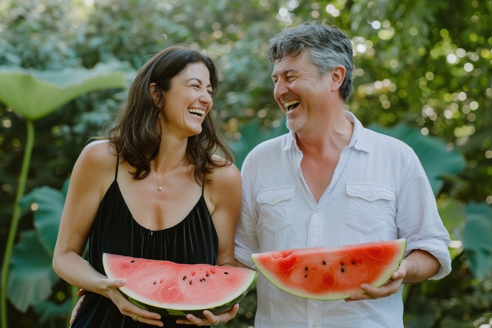 Middle-aged couple laughing watermelon holding summer.