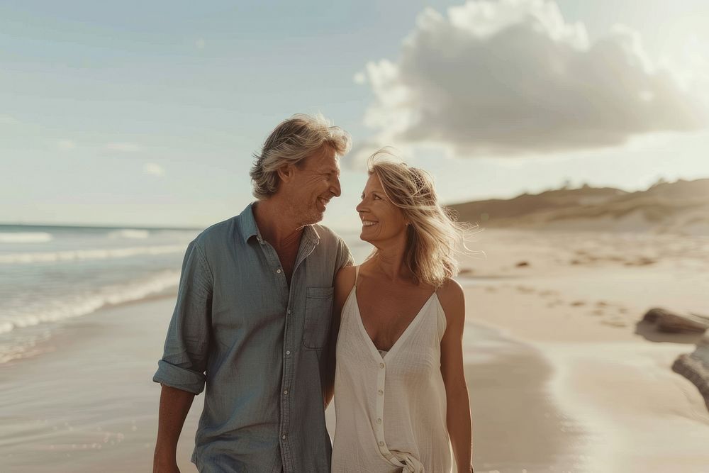 Middle-aged couple walking together romantic summer beach.