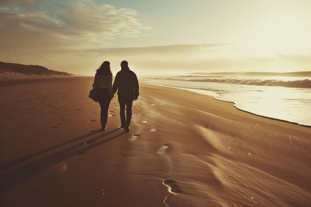 Middle-aged couple walking together beach outdoors nature.