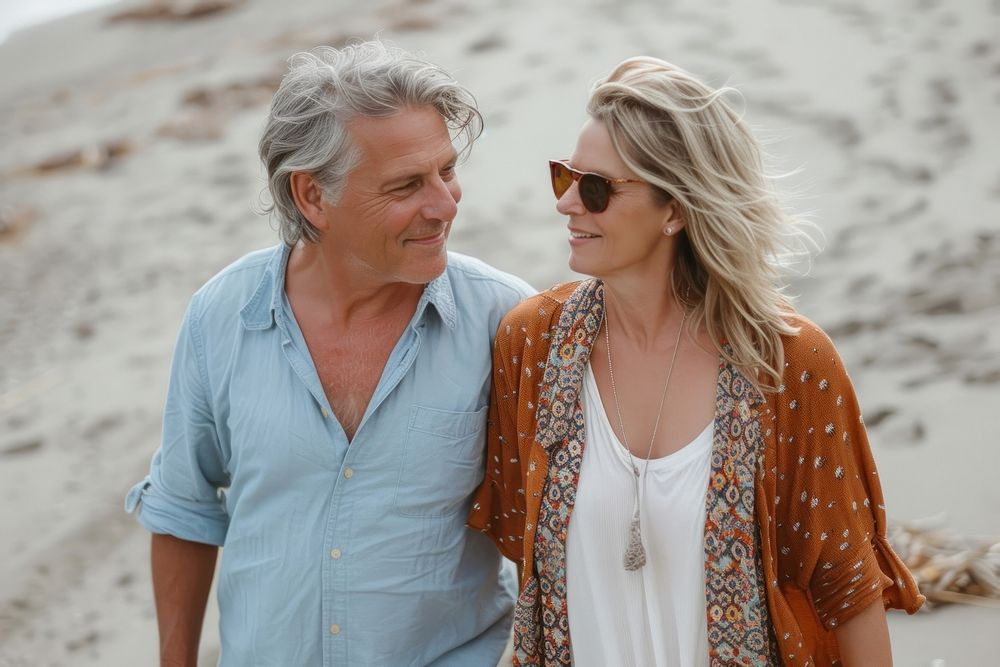 Middle-aged couple walking together portrait adult beach.