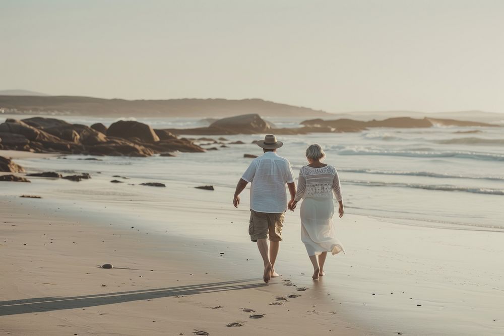 Middle-aged couple walking together vacation summer beach.