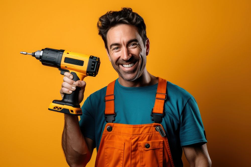 Man holding a drill smiling tool construction.