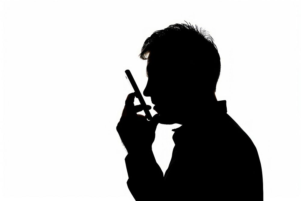 A man talking on a cell phone silhouette smoking white.