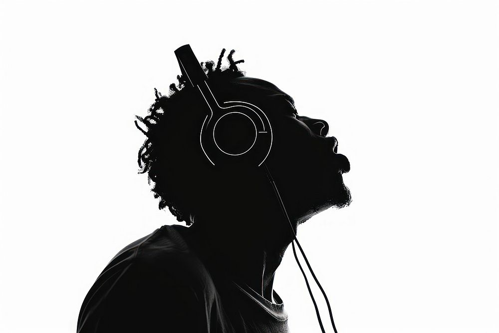 A man singing with a headphone on silhouette headphones adult.