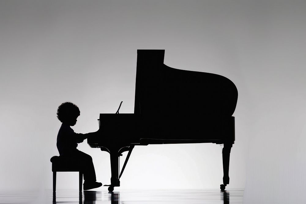 A piano and a kid silhouette keyboard musician.