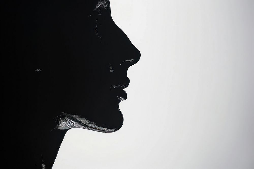 A profile face silhouette adult white backlighting.