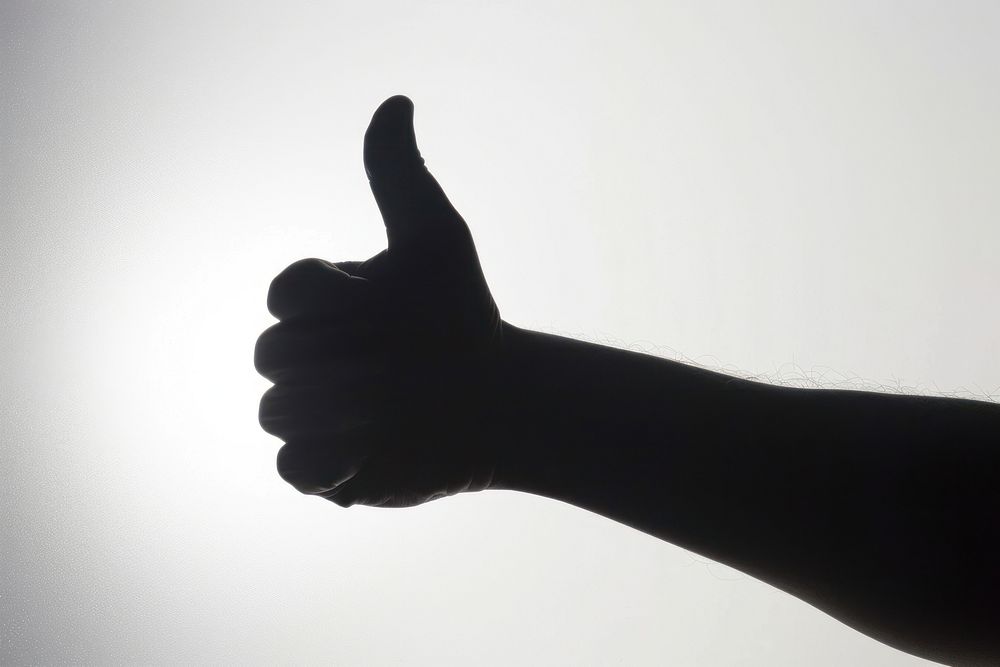 A thumb up silhouette finger hand gesturing.